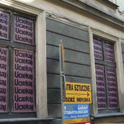 UCIEKAJ, 2003, druk na folii samoprzylepnej. Zaklejone okna galerii Szarej w Cieszynie w czasie wystawy „Borders and Beyond”